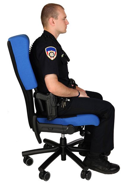 Police officer seated in a Shield law enforcement chair with full duty belt clearance