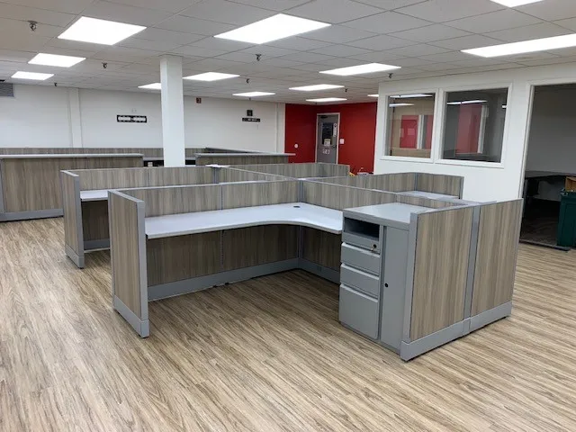 Open-plan cubicle system with a red accent wall, Offices For Less, Arvada, Colorado